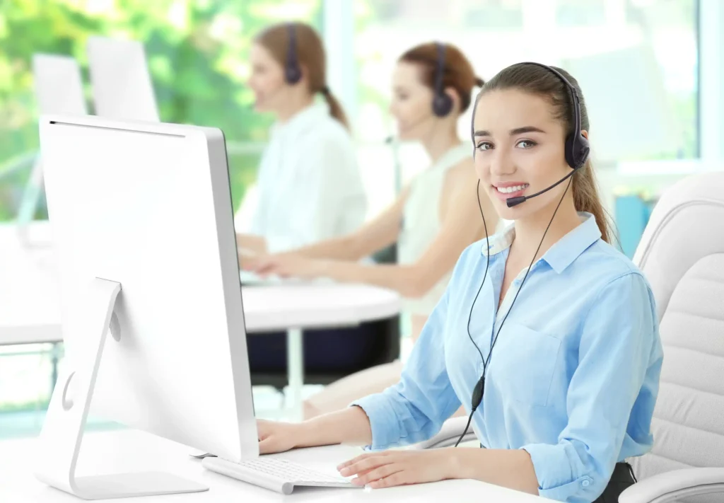 Young female technical support dispatcher working in office.