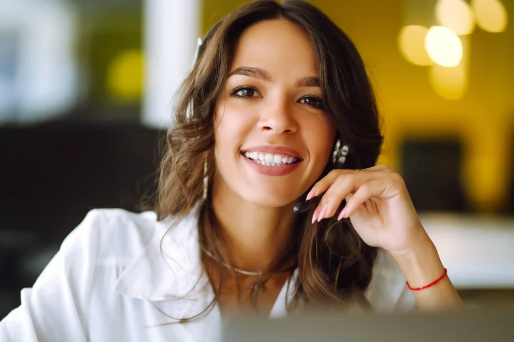 Young operator woman with headsets working in a call center.